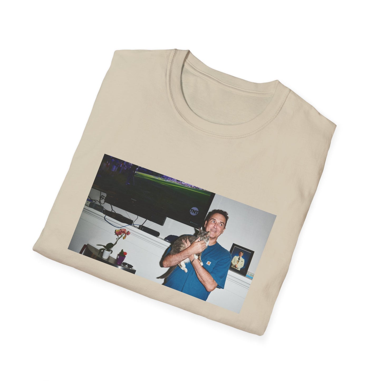 norm macdonald and his cat in front of a framed picture of steve martin tshirt